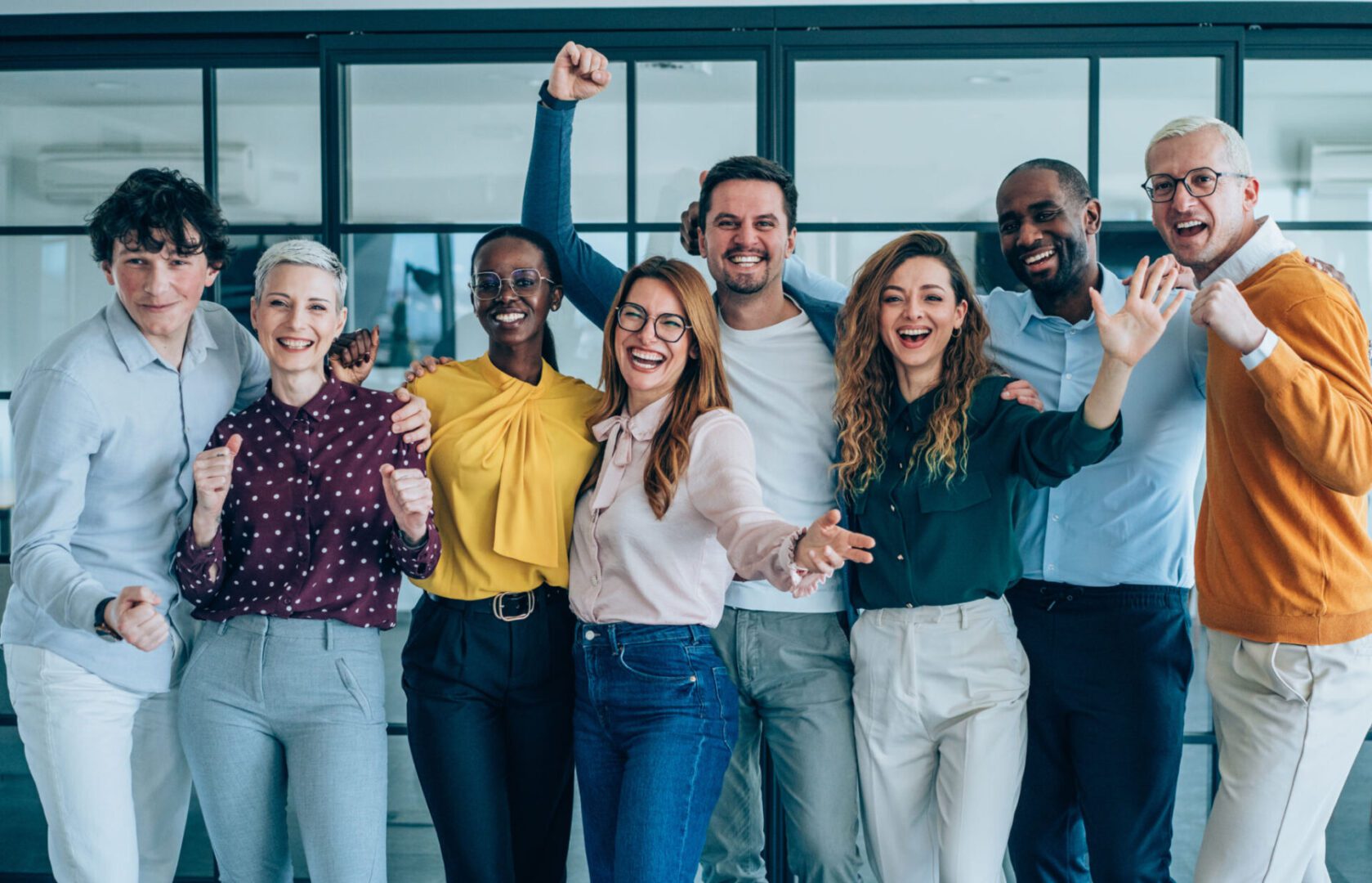 Diverse group celebrating in an office setting.