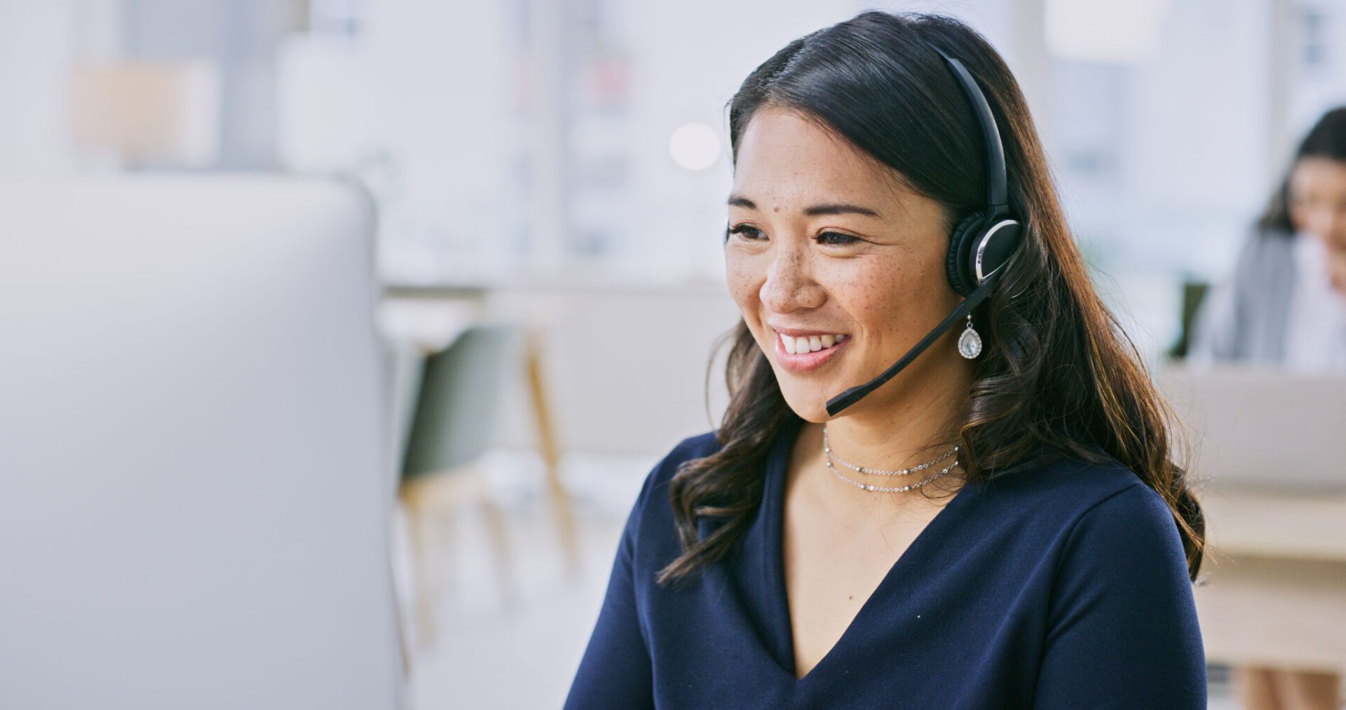 Woman smiling with a headset on.