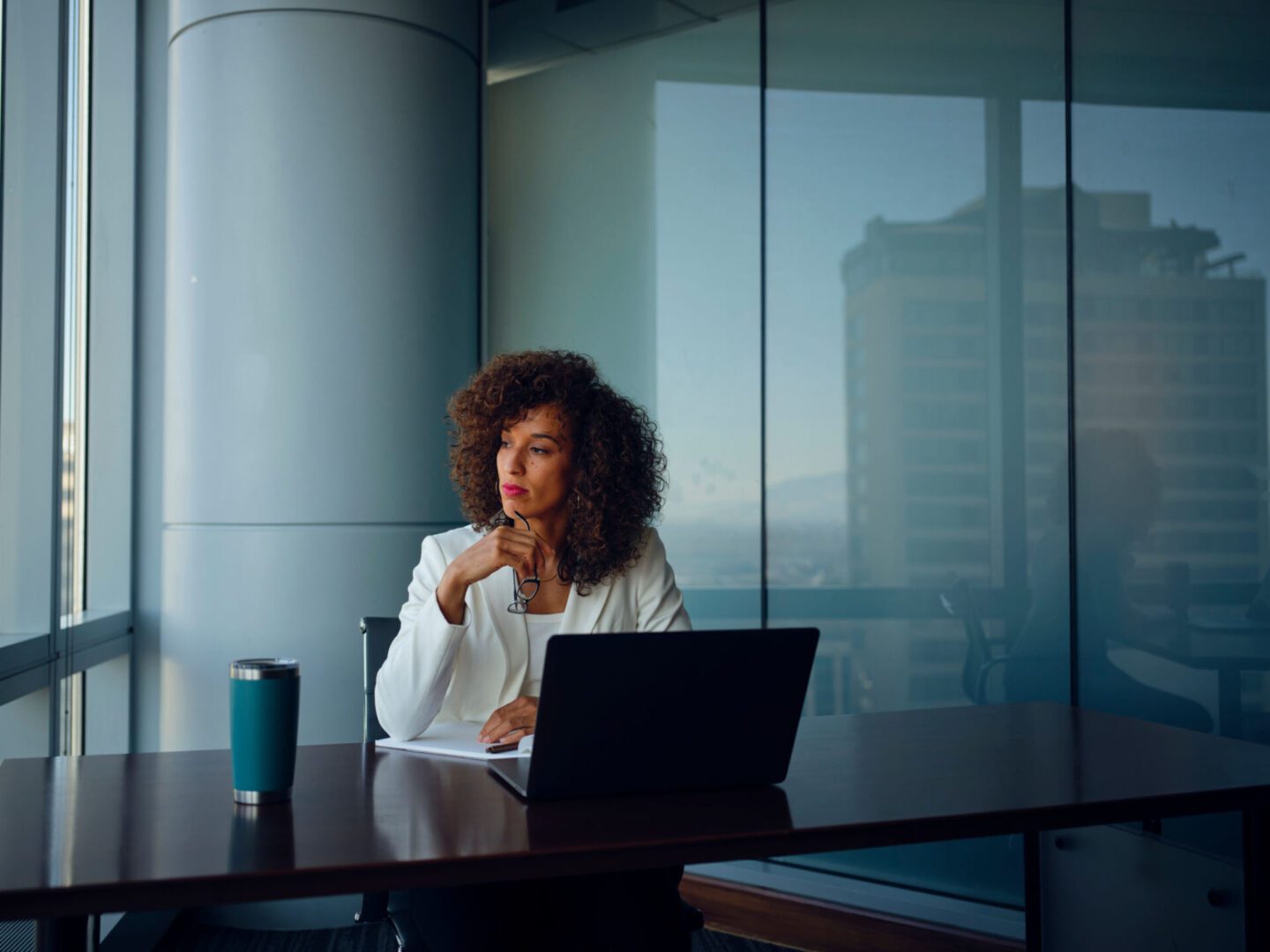 Woman working at laptop in office.